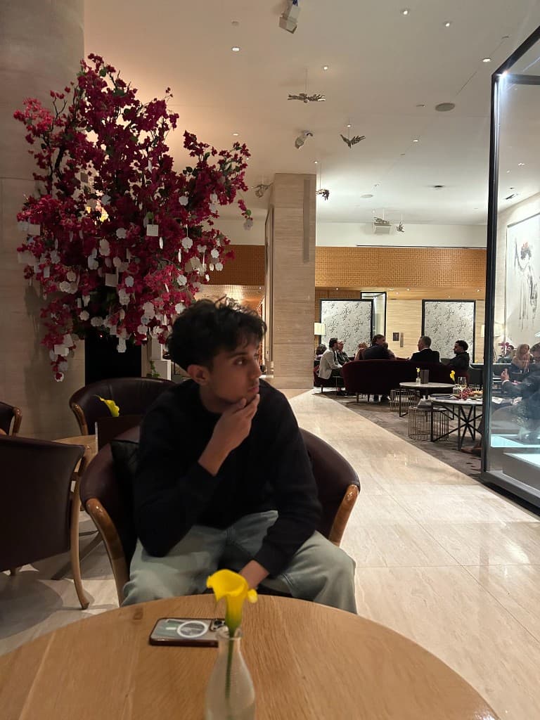 Sitting in a hotel lounge by a pink wish tree